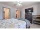 Well-lit bedroom with a ceiling fan, dresser, and a view through the window to the outside patio at 12925 W Llano Dr, Litchfield Park, AZ 85340