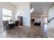 Formal dining room with large windows, chandelier, dark wood table and chairs, and tiled flooring at 12925 W Llano Dr, Litchfield Park, AZ 85340