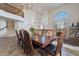 Spacious dining area with dark wood table, seating for eight, chandelier, and views of the upper level at 12925 W Llano Dr, Litchfield Park, AZ 85340