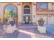 Charming home entrance featuring a brick pathway, potted plants, and an American flag on display at 12925 W Llano Dr, Litchfield Park, AZ 85340