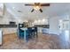 Bright eat-in kitchen features a large island, stainless steel appliances, white cabinets and tile backsplash at 12925 W Llano Dr, Litchfield Park, AZ 85340