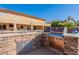 Exterior kitchen with granite countertops, stainless steel grill and sink at 12925 W Llano Dr, Litchfield Park, AZ 85340