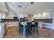 Bright eat-in kitchen features a large island, stainless steel appliances, white cabinets and tile backsplash at 12925 W Llano Dr, Litchfield Park, AZ 85340