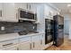 Kitchen features white cabinets, stainless appliances, gray subway tile and light countertops at 12925 W Llano Dr, Litchfield Park, AZ 85340