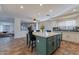 Bright eat-in kitchen features a large island, stainless steel appliances, white cabinets and tile backsplash at 12925 W Llano Dr, Litchfield Park, AZ 85340