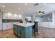 Bright eat-in kitchen features a large island, stainless steel appliances, white cabinets and tile backsplash at 12925 W Llano Dr, Litchfield Park, AZ 85340