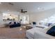 Open living area with comfortable seating, ceiling fan, and an open view into the kitchen at 12925 W Llano Dr, Litchfield Park, AZ 85340