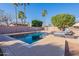 Outdoor pool with a lounge area, desert landscape, and privacy fence at 12925 W Llano Dr, Litchfield Park, AZ 85340