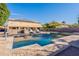 Backyard oasis with refreshing pool, lush landscaping, outdoor kitchen and lounge chairs at 12925 W Llano Dr, Litchfield Park, AZ 85340