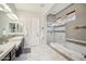 Elegant bathroom featuring double sinks, a walk-in shower, and a soaking tub at 12956 W Eagle Ridge Ln, Peoria, AZ 85383