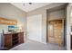 Neutral bedroom with a dark media center, wooden dresser and a sliding door closet at 12956 W Eagle Ridge Ln, Peoria, AZ 85383