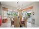 Bright dining area featuring a wooden table, wicker chairs, and views of the backyard at 12956 W Eagle Ridge Ln, Peoria, AZ 85383