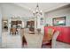 Charming dining room with a round wooden table, stylish chairs, and adjacent kitchen view at 12956 W Eagle Ridge Ln, Peoria, AZ 85383