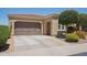 A home featuring desert landscaping, neutral paint, a large garage and a security camera at 12956 W Eagle Ridge Ln, Peoria, AZ 85383