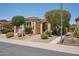 Inviting single-story home with desert landscaping, a wrought-iron gate, and an attached two-car garage at 12956 W Eagle Ridge Ln, Peoria, AZ 85383