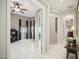 Hallway featuring tile flooring with open doors to the dining and living rooms at 12956 W Eagle Ridge Ln, Peoria, AZ 85383