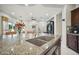 Kitchen island featuring granite counters, double sinks, and stainless steel appliances at 12956 W Eagle Ridge Ln, Peoria, AZ 85383