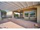 Covered patio featuring brick pavers and an outdoor dining area, perfect for entertaining at 12956 W Eagle Ridge Ln, Peoria, AZ 85383