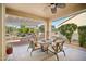 Covered patio featuring outdoor seating area with a fire pit and a ceiling fan at 12956 W Eagle Ridge Ln, Peoria, AZ 85383