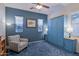 Bedroom with a murphy bed, blue accent wall, chair, and soft, neutral-toned walls at 13054 W Big Oak St, Peoria, AZ 85383