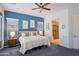 Serene bedroom with ensuite bathroom and a plush bed complimented by blue accent wall at 13054 W Big Oak St, Peoria, AZ 85383