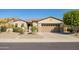 Attractive home with well-manicured front yard, desert landscaping, and spacious garage at 13054 W Big Oak St, Peoria, AZ 85383