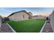 Large backyard showcasing artificial turf, patio furniture and privacy walls at 13487 W Buckskin Trl, Peoria, AZ 85383