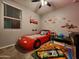 Themed bedroom with a race car bed and complementary decor for children at 13487 W Buckskin Trl, Peoria, AZ 85383