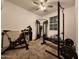 Carpeted home gym with weights, weight machines, and exercise bike at 13487 W Buckskin Trl, Peoria, AZ 85383