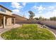 Green backyard featuring rock landscaping, a concrete patio, a covered patio, and a block fence at 14309 W Weldon Ave, Goodyear, AZ 85395