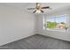 Bedroom with carpet, a ceiling fan, and a window overlooking the home's exterior at 14309 W Weldon Ave, Goodyear, AZ 85395