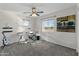 Spacious bedroom with carpet, ceiling fan, a guitar, and a drumset next to the window at 14309 W Weldon Ave, Goodyear, AZ 85395