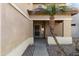 A view of the front porch, featuring a security door and well maintained yard at 14309 W Weldon Ave, Goodyear, AZ 85395