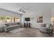 Bright living room with neutral walls, wood floors, modern decor and lots of light at 14309 W Weldon Ave, Goodyear, AZ 85395