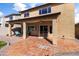 Expansive covered patio area with tile flooring, ceiling fan and comfortable outdoor seating at 14309 W Weldon Ave, Goodyear, AZ 85395