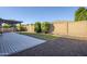 This backyard features a patio with pergola, gravel landscaping, artificial turf and block fence at 14762 W Georgia Dr, Surprise, AZ 85379