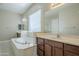 Beautiful Primary bathroom with soaking tub, dual sinks, and abundant natural light offers a spa-like experience at 14762 W Georgia Dr, Surprise, AZ 85379