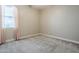 Neutral-toned bedroom featuring a large window adorned with a curtain at 14762 W Georgia Dr, Surprise, AZ 85379