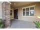 Inviting front porch with decorative brick pillars and ample space, framed by lush landscaping at 14762 W Georgia Dr, Surprise, AZ 85379