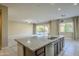 Kitchen with granite countertops and stainless steel appliances adjacent to the living room with sliding glass doors at 14762 W Georgia Dr, Surprise, AZ 85379