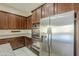 A modern kitchen featuring stainless steel appliances, including a refrigerator and double oven at 14762 W Georgia Dr, Surprise, AZ 85379