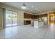 A spacious kitchen with an island that opens to a bright living space with tile floors at 14762 W Georgia Dr, Surprise, AZ 85379