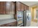 A modern kitchen featuring stainless steel appliances, including a refrigerator and double oven at 14762 W Georgia Dr, Surprise, AZ 85379