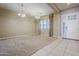 Inviting living room with neutral walls, carpet, and multiple windows allowing natural light at 14762 W Georgia Dr, Surprise, AZ 85379