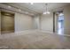 Open-concept living room with neutral color palette, carpet, and recessed lighting, ready for personalization at 14762 W Georgia Dr, Surprise, AZ 85379