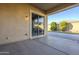 A covered patio featuring a ceiling light and sliding glass door entry to the residence at 14762 W Georgia Dr, Surprise, AZ 85379