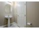 Stylish powder room with pedestal sink and decorative lighting at 14762 W Georgia Dr, Surprise, AZ 85379