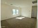 Carpeted bedroom featuring natural light from a window, offering a cozy and serene atmosphere at 1588 N Pueblo Dr, Apache Junction, AZ 85120