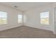 Carpeted bedroom with ample natural light from dual windows at 1588 N Pueblo Dr, Apache Junction, AZ 85120