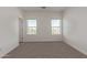 Carpeted bedroom with two windows and neutral paint at 1588 N Pueblo Dr, Apache Junction, AZ 85120